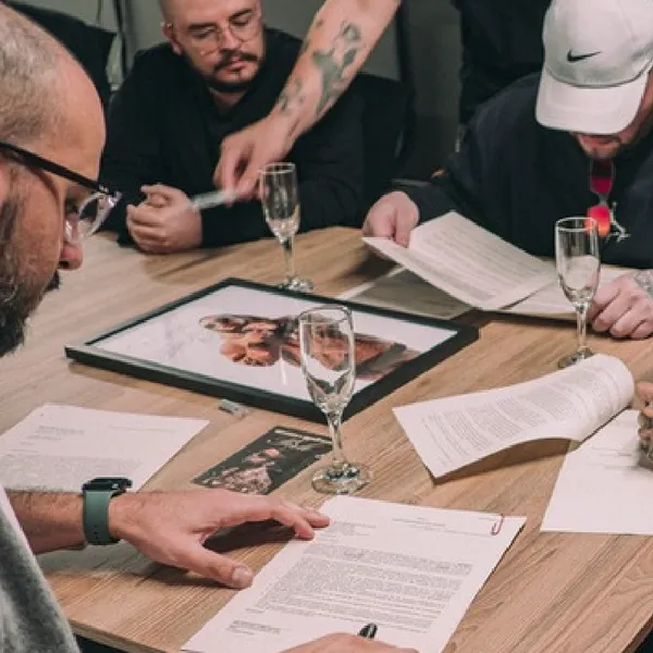 Grupo de personas revisando diferentes contratos sobre una mesa